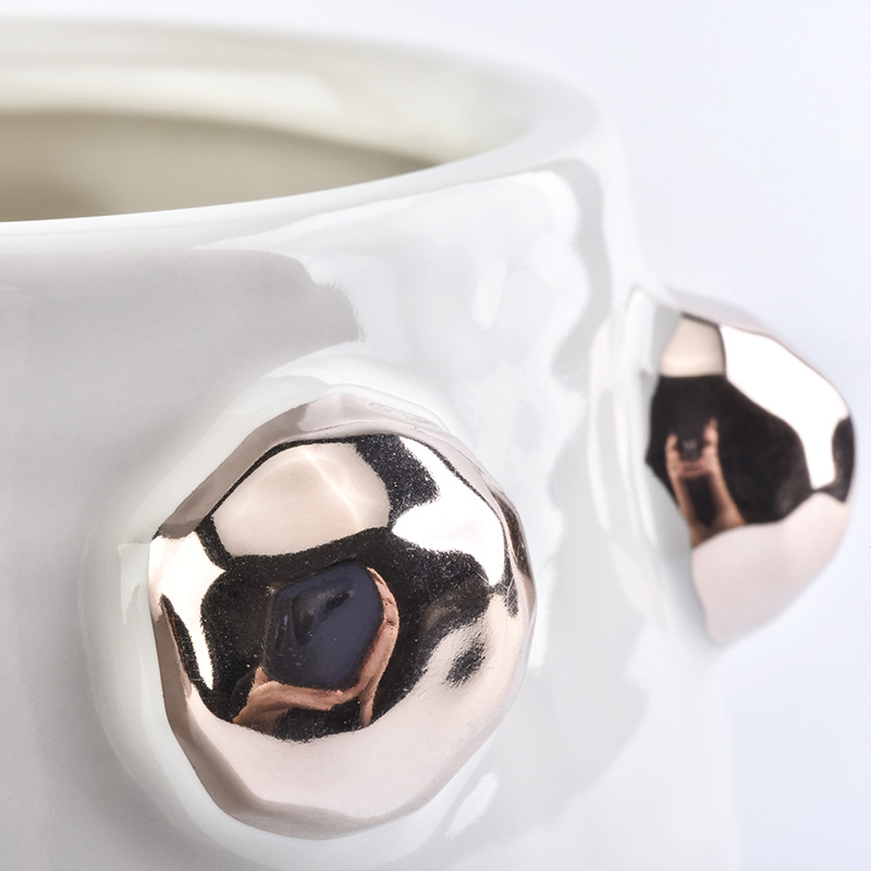 white ceramic candle jar with shiny golden dots
white ceramic candle jar with shiny golden dots