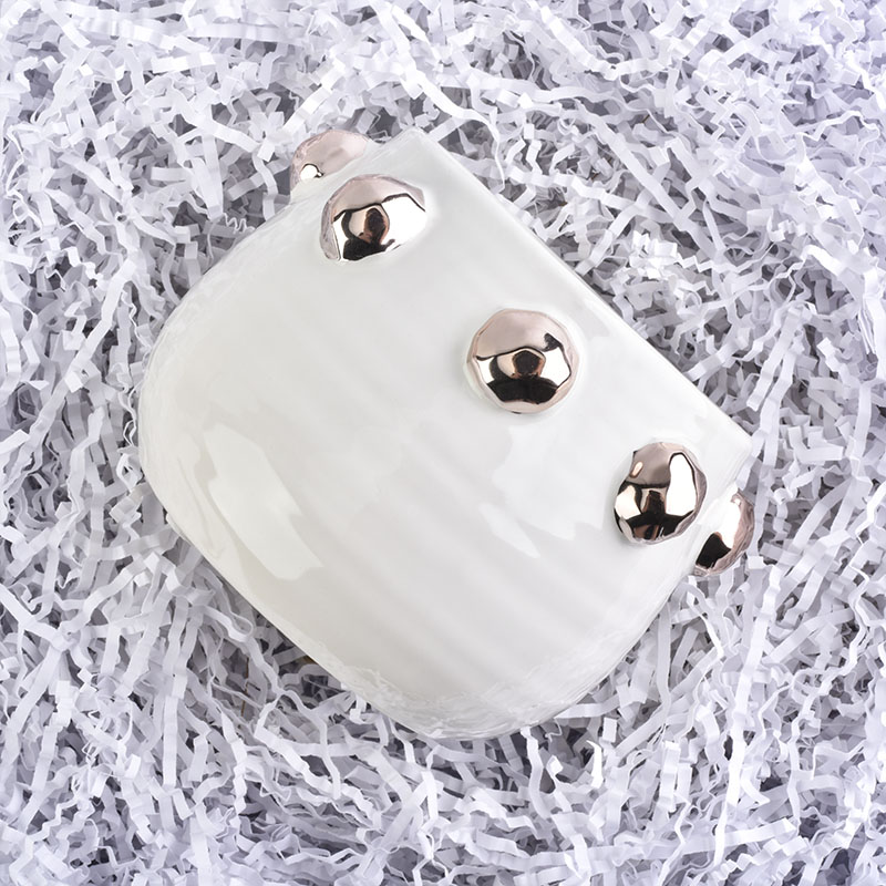 white ceramic candle jar with shiny golden dots
white ceramic candle jar with shiny golden dots