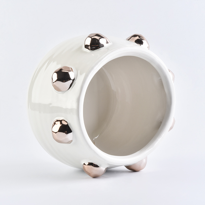 white ceramic candle jar with shiny golden dots
white ceramic candle jar with shiny golden dots