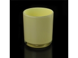 Yellow painted cylindrical glass vessel for candles